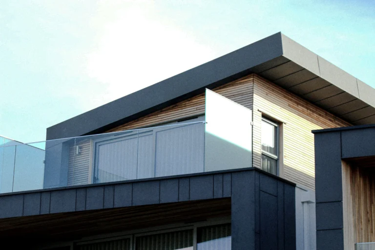 Modern luxury home exterior with clean lines and glass balcony, symbolizing stability, ownership, and long-term wealth preservation.